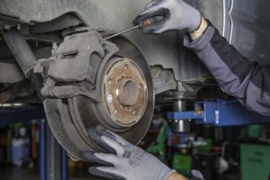 anti seize mechanic doing a brake job 